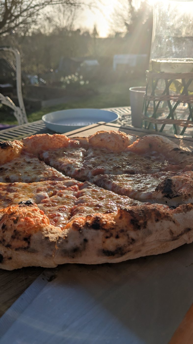 Neapolitan-style pizza with puffy cornicione and melted mozzarella