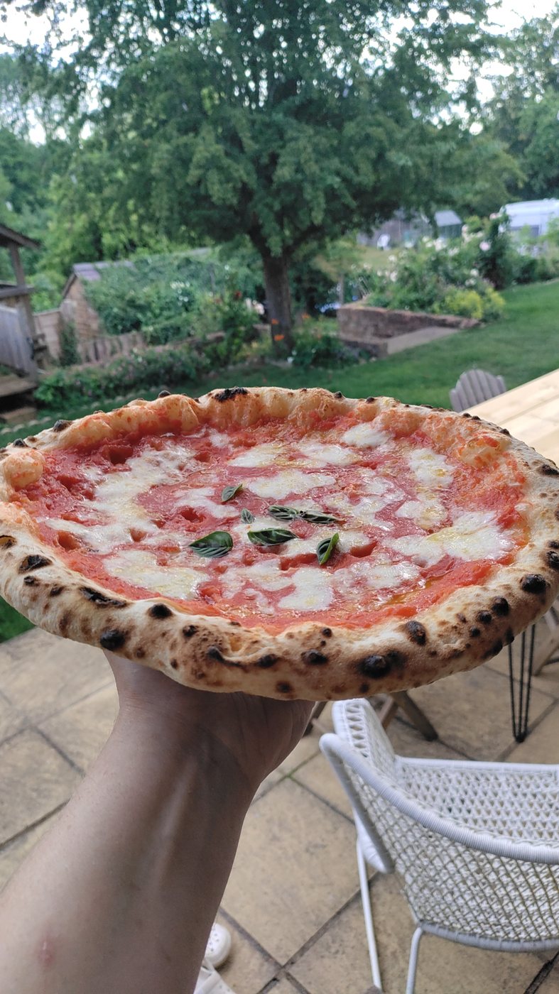 Whole Neapolitan-style pizza with puffy leopard-spotted crust